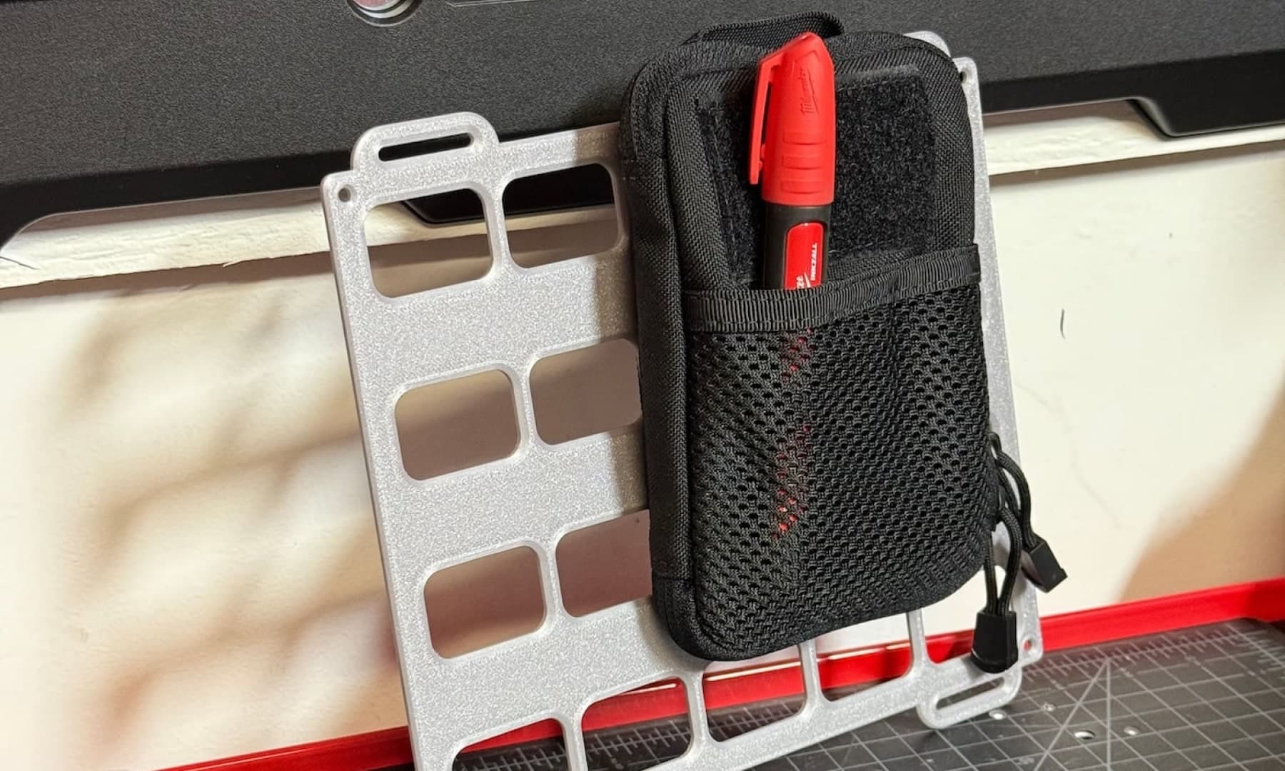 Small black bag attached to a molle panel